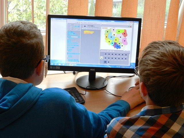 digital divide - two students work on a computer