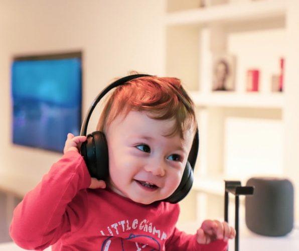 young child listens to music